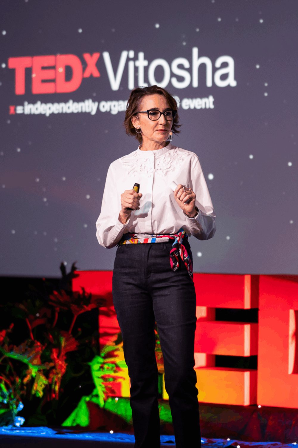 Ani Filipova speaking on stage at TEDx Vitosha
